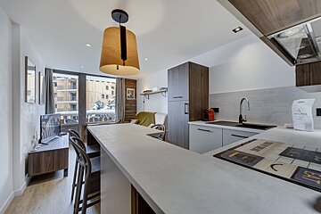 A kitchen with a bag of les alpes on the counter