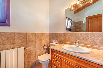 A bathroom with a toilet a sink and a mirror