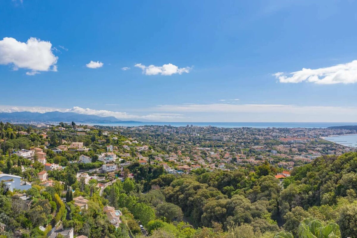 An aerial view of a city with mountains in the background