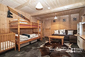 A living room with bunk beds and a couch from mountain base