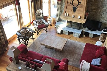 A living room with a red couch and a fireplace