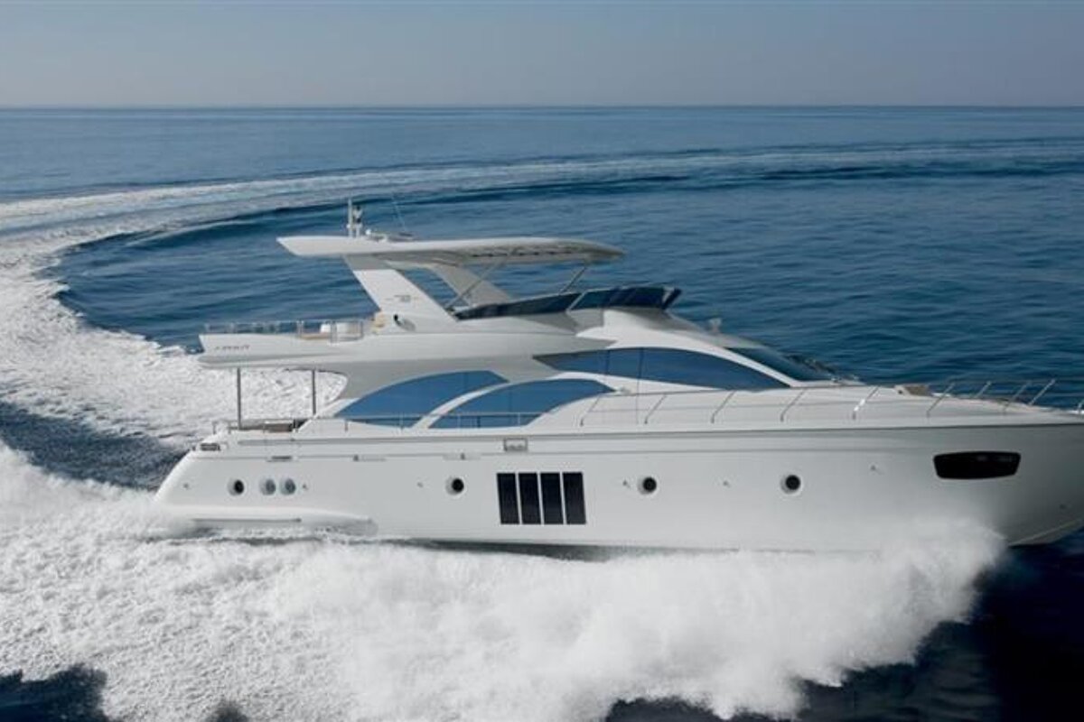 A large white yacht is floating in the ocean