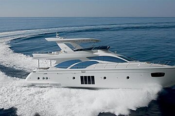 A large white yacht is floating in the ocean