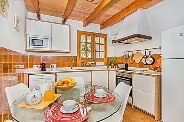 A kitchen with a refrigerator that says indesit on it
