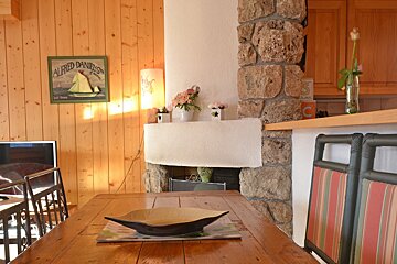 A picture of a sailboat is above a wooden table