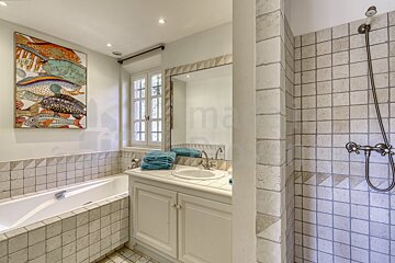 A bathroom with a picture of fish on the wall