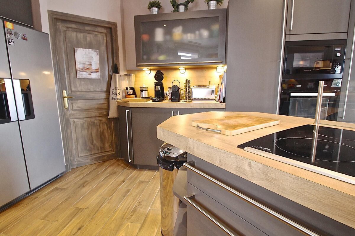 A kitchen with a cutting board on the counter and a sign on the door that says 