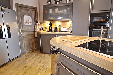 A kitchen with a cutting board on the counter and a sign on the door that says