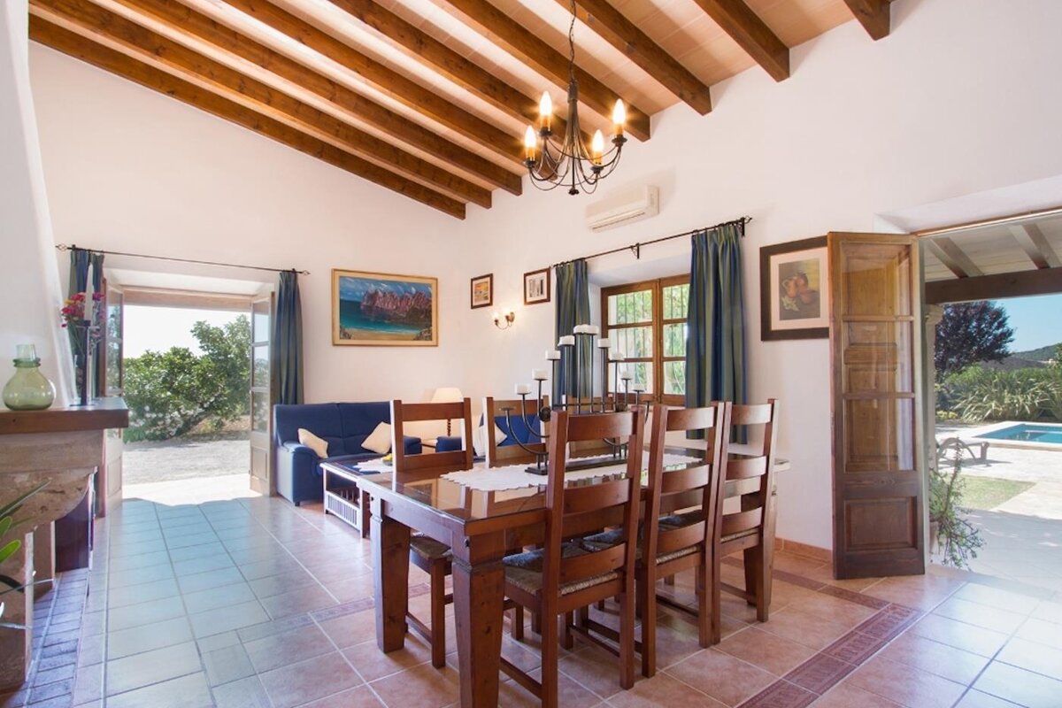 A living room with a dining table and chairs