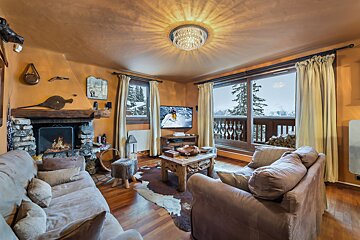 A living room with a fireplace and a flat screen tv