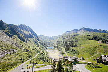 The sun is shining brightly over the mountains