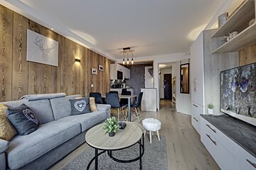 A living room with a couch a table and a television