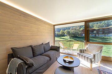 A living room with a table and chairs and a fireplace