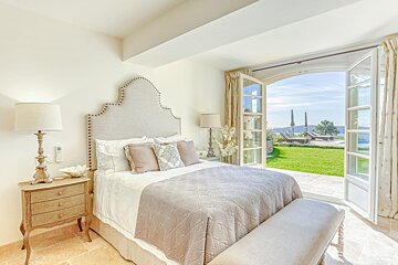 A bedroom with a bed and a window with a view
