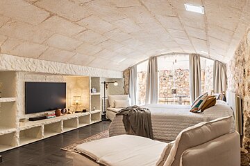 A bedroom with two beds and a flat screen tv