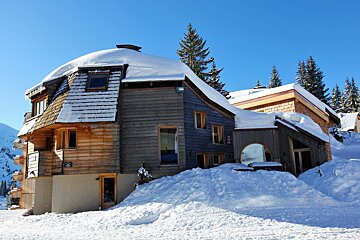 A snowy house with a sign that says ' a ' on it