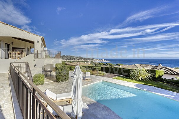 A large house with a swimming pool in front of it