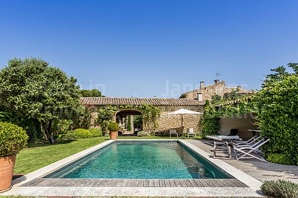 A large swimming pool in front of a stone building