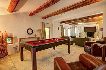 A pool table in the middle of a living room
