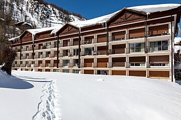 A large building with a blue sky in the background