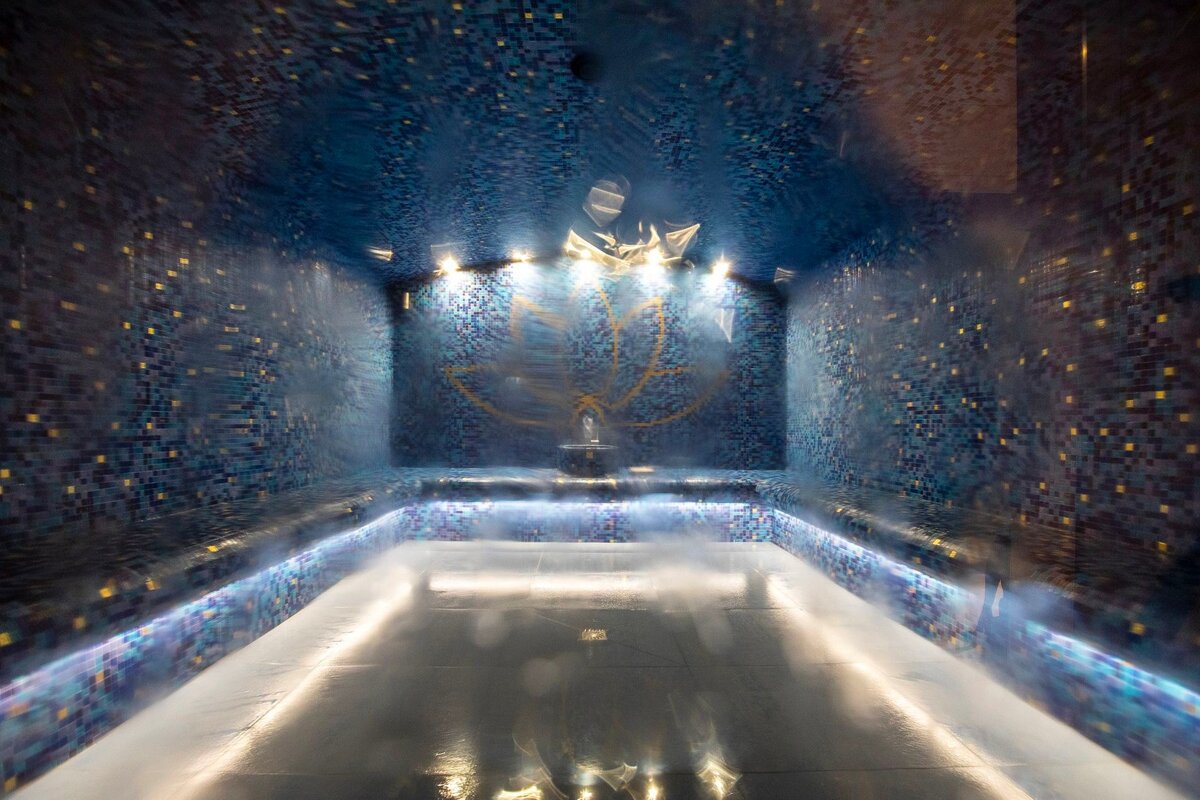 A dark room with a lotus design on the ceiling