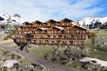 Modern wooden mountain chalets on a snowy hillside with snow-covered peaks in the background.