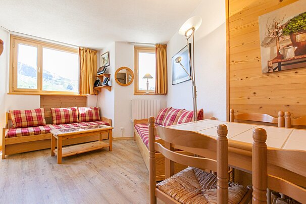 A living room with a couch a table and chairs