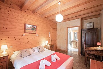 A bedroom with a bed and a picture on the wall
