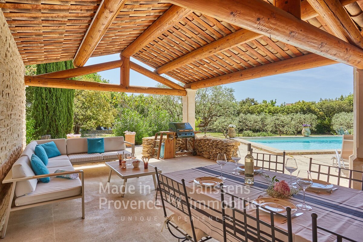 A patio with a table and chairs and a sign that says made in provence