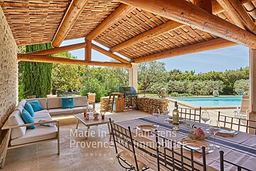 A patio with a table and chairs and a sign that says made in provence