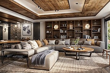 A spacious, modern living room featuring a large gray sectional sofa, impressive wooden ceiling, built-in bookshelves, and warm, earthy decor.