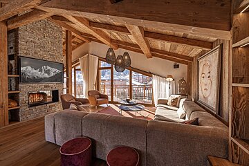 A living room with a couch and a television on the wall