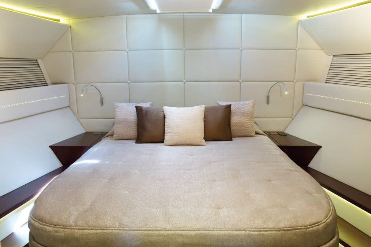 A bedroom with a bed and pillows on it