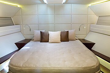 A bedroom with a bed and pillows on it