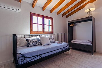 A bed with blue and white pillows in a bedroom