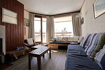 A living room with a couch and two tables