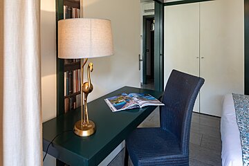 A desk with a lamp and a book on it
