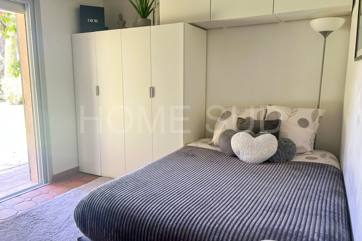 A bedroom with a bed and a dior box above it