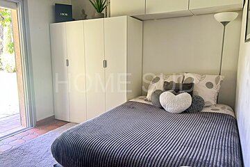 A bedroom with a bed and a dior box above it