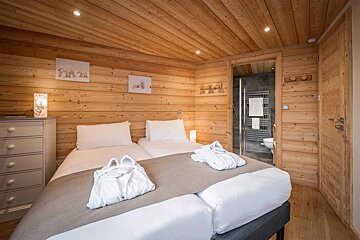 A bedroom with two beds and a picture of polar bears on the wall
