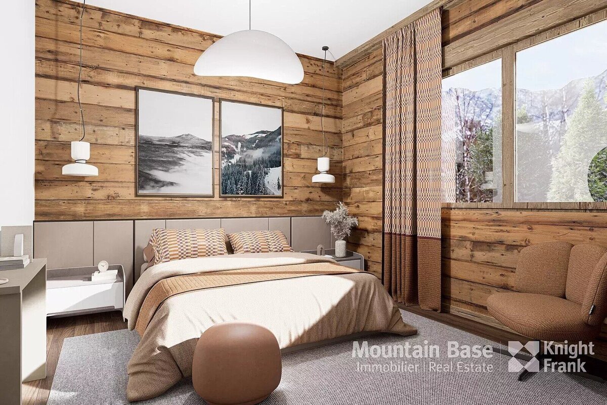 A rustic modern bedroom with wood paneling, a large bed, mountain-themed art, and a window offering a view of snowy peaks.