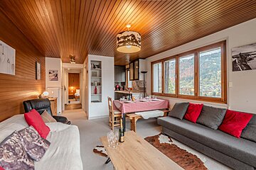 A bedroom with a king size bed and a balcony