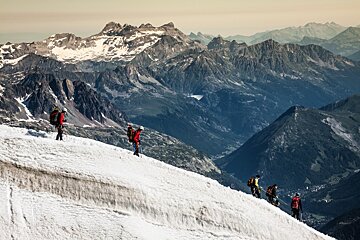 A group of people are hiking up a snowy mountain