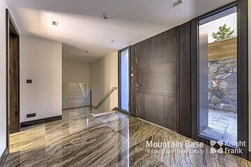 A hallway with a large door and a sign that says mountain base
