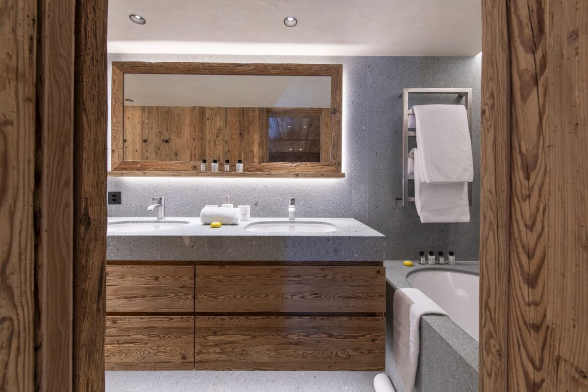 A bathroom with two sinks and a large mirror