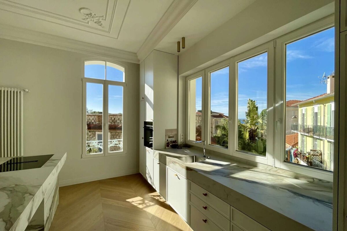A kitchen with a lot of windows and a sink