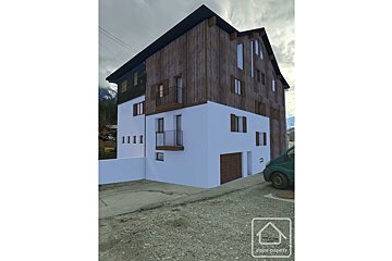 A 3d rendering of a house with a van parked in front of it