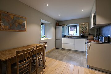 A kitchen with a map of the world on the wall