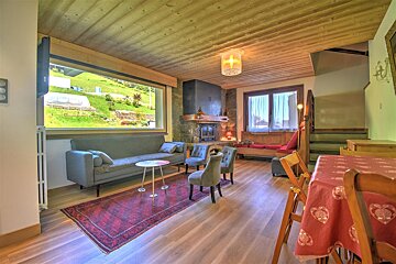 A living room with a couch and chairs and a fireplace