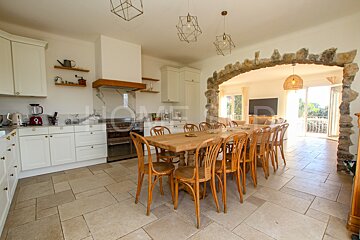 A kitchen with a table and chairs and the word home on the wall